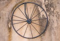 Rod iron bicycle wheel on dirty concrete wall background texture Royalty Free Stock Photo