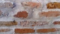 Old roman brick. The restored wall of the building of the Roman conquerors. Warm brown-red shades of uneven bricks. Archaeological Royalty Free Stock Photo