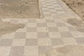Old roman tiled walkway in chessboard pattern, detail of Ruins of Italica, Roman city in the province of Hispania Baetica