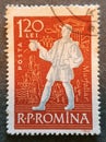 old Romanian stamp circa 1960 with the image of a peasant with a cup of wine