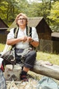 An old Romanian woman carve wooden spoons