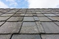 Old roof slate tiles roof with blue sky and clouds. Royalty Free Stock Photo