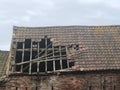 An Old Roof with Tiles Missing and a Hole in it After A Storm Royalty Free Stock Photo