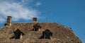 Old roof tiles with tv antenna and chimneys Royalty Free Stock Photo