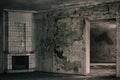 An old room with an antique fireplace and shabby walls. Royalty Free Stock Photo