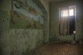 An old room with a beautiful wall in an abandoned manor house. Light from a broken window. Royalty Free Stock Photo