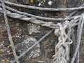 Old rope, ropes hanging on stone wall. Royalty Free Stock Photo