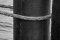 An old rope tied around a metal pipe Royalty Free Stock Photo