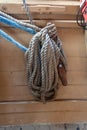 Old ropes coiled around a rusted metal cleat on an old fishing boat