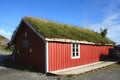 Old rorbu with grass on the roof in Sund
