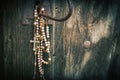 Old rosary against ancient wooden background. Horisontal image