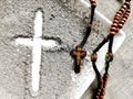 Old rosary and ash - symbols of Ash Wednesday. Canvas background. Top view. Royalty Free Stock Photo