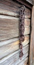 Old rosty chain on a barn wall