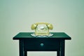 Old rotary dial telephone on a table, with a retro effect Royalty Free Stock Photo