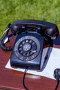 Vintage black rotary phone on a desk Royalty Free Stock Photo