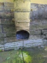 old and rotten drainage pipe of the building in the summer. Royalty Free Stock Photo