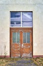 Old rotten wooden front door with peeling paint Royalty Free Stock Photo