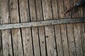 Old rotten wormy ancient oak door and metal parts, wooden textured castle door