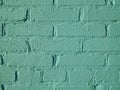 Abstract textured background of old brick wall painted with light green paint closeup Royalty Free Stock Photo