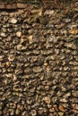 Textured flint stone wall background showing aging bricks, rustic grunge, and natural moss growing Royalty Free Stock Photo
