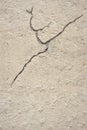 Old rough gray wall with a crack on plaster.  Structured Grunge Textured Background Royalty Free Stock Photo