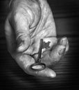 Old Rough Hand Holding Old Key Giving Away Knowledge Key to Success Royalty Free Stock Photo