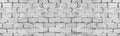 Old rough light gray exterior brick wall wide texture. Aged shabby masonry. Grunge brickwork large long background Royalty Free Stock Photo