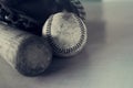 Old rough and rugged baseball and vintage wooden bat on blue texture background. Royalty Free Stock Photo