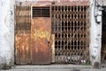 Closed old weathered rusty metal door in slum district. Royalty Free Stock Photo