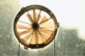 Old round bathroom window vent with light behind it Royalty Free Stock Photo