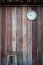 Old round clock hang on old wooden wall Royalty Free Stock Photo