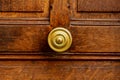 Old round door handle on old wooden brown door. Close up Paris, France. Gold brass details on old wooden door. Handle on brown old Royalty Free Stock Photo