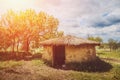 Old round house with thatched roof in sunlight Royalty Free Stock Photo