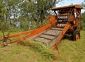 Old round orange hay baler Royalty Free Stock Photo