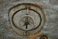 Old round rusty tank faucet close-up outdoors Royalty Free Stock Photo