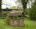 Old Wishing Well made of Brick and a Tiled Roof.