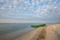 Old row boat on the coastline. Wide angle. Royalty Free Stock Photo