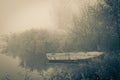 Old row boat at the waterfront in a misty frozen scenery Royalty Free Stock Photo