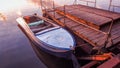 Old rowboat moored pier amazing sunset lake river Royalty Free Stock Photo