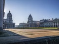 Old Royal Naval College doors entrance near Times river and the sun shining above. Royalty Free Stock Photo