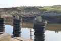 Old rubber tyres stacked up on wooden posts at a mooring spot on the river Axe in Axmouth. The tyres prevent damage to the boats Royalty Free Stock Photo