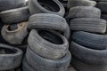 Old rubber vehicle tires and car wheel inner tubes a lot. Tire changing service or collecting old damaged rubber. The Royalty Free Stock Photo