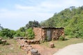 An old ruin abandoned house in mountain forest. Damaged broken demolished ruined fortified brick wall building exterior. Royalty Free Stock Photo