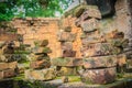 Old ruin brick wall covered with green moss and small grass. Old khmer sanctuary brick wall overgrown with green moss. Royalty Free Stock Photo