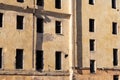 Old ruined abandoned building without windows, yellow walls