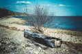 Old ruined boat on the beach. Abandoned fishing boat