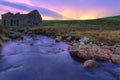 An old ruined bothy on a Scottish moor and a creek flows through