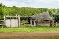 Old ruined buildings in a rustic manor with a green forest background