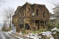 Old and ruined house in snow, color photo