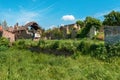 Old ruined houses with back yards in grass